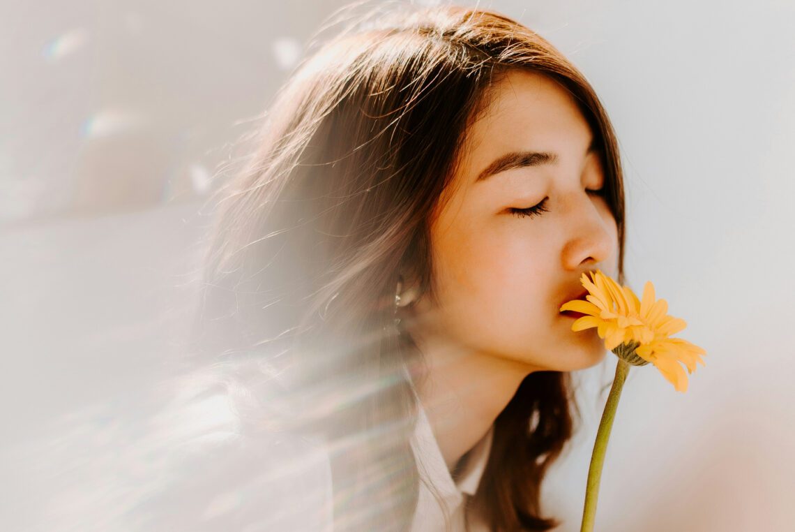 woman smelling a flower -- Photo by Anthony Tran on Unsplash