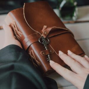 woman hand holding an old diary