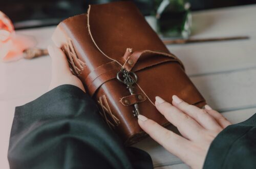 woman hand holding an old diary